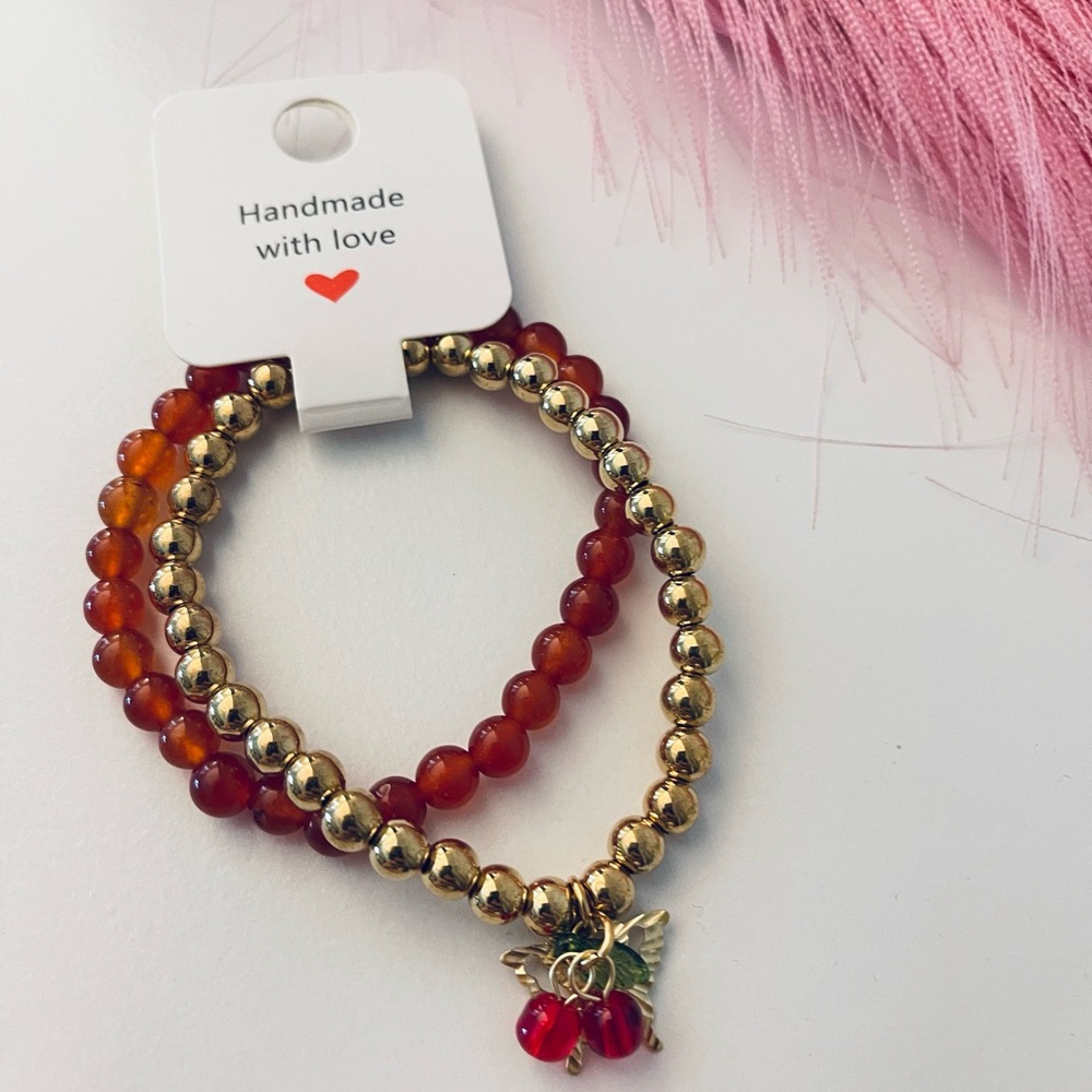 Handmade Red and Gold Beaded Bracelet Set with cherry and butterfly charms.